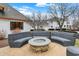 Inviting backyard patio features a stone fire pit and curved seating, perfect for outdoor entertaining and relaxation at 2071 Eagle Trace Dr, Greenwood, IN 46143