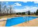 Backyard swimming pool surrounded by manicured landscaping and lounge chairs at 2071 Eagle Trace Dr, Greenwood, IN 46143