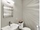 Well-lit powder room featuring a decorative mirror, a pedestal sink, and a convenient toilet basket at 2071 Eagle Trace Dr, Greenwood, IN 46143