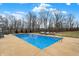 Large in-ground swimming pool with surrounding patio space and lawn chairs for soaking up the sun at 2071 Eagle Trace Dr, Greenwood, IN 46143