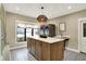 Utility room with a large island, modern appliances, decorative tile flooring, and natural light at 2071 Eagle Trace Dr, Greenwood, IN 46143