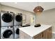 Utility room featuring modern appliances, a large island, sink and door to the outside at 2071 Eagle Trace Dr, Greenwood, IN 46143