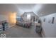 Cozy attic bedroom with neutral carpet, sloped ceiling, and a large window at 401 E Ohio St, Fortville, IN 46040