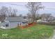 A spacious, fenced backyard with a deck and lush green grass provides privacy and room for outdoor activities at 401 E Ohio St, Fortville, IN 46040