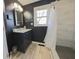 Modern bathroom featuring a vanity sink, stylish mirror, and tiled walk-in shower at 401 E Ohio St, Fortville, IN 46040