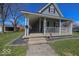 Charming two-story home with a covered front porch and well-maintained lawn at 401 E Ohio St, Fortville, IN 46040