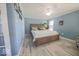 Serene main bedroom with blue walls, a large bed, and ample natural light at 401 E Ohio St, Fortville, IN 46040