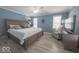 Spacious main bedroom with a plush bed, stylish decor, and comfortable seating at 401 E Ohio St, Fortville, IN 46040