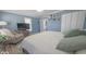 Bright main bedroom offering a large bed, cozy chair, and white closet doors at 401 E Ohio St, Fortville, IN 46040