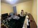 Bedroom features yellow walls, lots of personal items, and a large blanket on the bed at 504 E Walnut St, Summitville, IN 46070