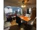 View of dining room and connecting living room, with hardwood floors and ceiling fan at 504 E Walnut St, Summitville, IN 46070