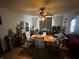 View of dining room with ceiling fan, hardwood floors, and arched doorway to living room at 504 E Walnut St, Summitville, IN 46070