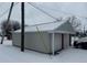 Two car garage with white doors and red trim, and covered in snow at 504 E Walnut St, Summitville, IN 46070