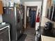 Standard kitchen with gray floors and stainless steel appliances, leading to dining room at 504 E Walnut St, Summitville, IN 46070
