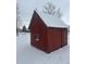Quaint red outbuilding in the backyard, covered with snow at 504 E Walnut St, Summitville, IN 46070