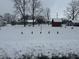 Winter street view showcasing front yards of neighborhood homes covered in snow at 504 E Walnut St, Summitville, IN 46070