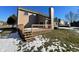 Exterior view of the home's backyard with wooden deck, patio doors, and snow covered lawn at 6462 Zionsville Rd, Indianapolis, IN 46268