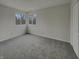Cozy bedroom with neutral carpet, bright windows, and a spacious closet at 6462 Zionsville Rd, Indianapolis, IN 46268