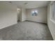 A spacious bedroom with plush carpeting and a large window offering ample natural light at 6462 Zionsville Rd, Indianapolis, IN 46268
