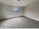A cozy bedroom featuring neutral walls, carpet and a window at 6462 Zionsville Rd, Indianapolis, IN 46268