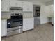 Well-lit kitchen showcases white cabinets, stainless steel appliances, and access to the living room at 6462 Zionsville Rd, Indianapolis, IN 46268