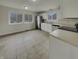 Bright kitchen featuring white cabinetry, stainless steel appliances, and tile flooring at 6462 Zionsville Rd, Indianapolis, IN 46268