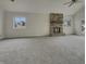 Bright living room with a stone fireplace, carpet and a vaulted ceiling at 6462 Zionsville Rd, Indianapolis, IN 46268