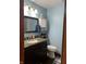 Bathroom with granite vanity, commode and wall storage at 720 Mount Rainier Dr, Indianapolis, IN 46217