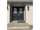 Elegant double front doors with glass detailing and decorative lights on a brick facade at 720 Mount Rainier Dr, Indianapolis, IN 46217
