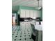 Eat-in kitchen featuring white cabinets, modern backsplash, and black appliances at 720 Mount Rainier Dr, Indianapolis, IN 46217