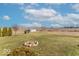Vast backyard with a rustic fire pit, surrounded by green space, offering a tranquil retreat at 7705 N State Road 42, Stilesville, IN 46180