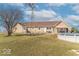 Spacious backyard with a pool, windmill, and a well-kept lawn, offering a perfect blend of leisure and charm at 7705 N State Road 42, Stilesville, IN 46180