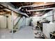 Unfinished basement with exposed pipes, water heater, washer and dryer, and painted walls at 7705 N State Road 42, Stilesville, IN 46180