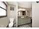 This bathroom has a large mirror, a vanity with a solid surface countertop, and a toilet at 7705 N State Road 42, Stilesville, IN 46180