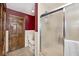 Bathroom featuring glass shower, tiled walls, toilet and wooden door at 7705 N State Road 42, Stilesville, IN 46180