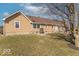 Well-maintained home exterior with a lush lawn, stone accents, and a tranquil backyard view at 7705 N State Road 42, Stilesville, IN 46180