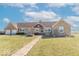Charming single-story home with a windmill and a well-manicured front lawn and stone accents at 7705 N State Road 42, Stilesville, IN 46180