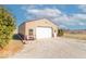 Detached garage with ample space, complemented by a serene outdoor setting and cozy seating area at 7705 N State Road 42, Stilesville, IN 46180