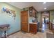 Spacious kitchen features wood cabinets, tile floors, and views into the dining area at 7705 N State Road 42, Stilesville, IN 46180