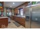 Well-lit kitchen featuring warm wood cabinetry and modern stainless steel appliances at 7705 N State Road 42, Stilesville, IN 46180