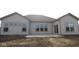 The backyard boasts a concrete patio and large windows, offering ample natural light indoors at 10502 Oak Bend Blvd, Indianapolis, IN 46239