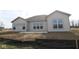 The backyard patio with big windows brightens the interior; landscaping is partially completed at 10502 Oak Bend Blvd, Indianapolis, IN 46239