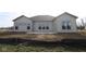 The backyard features a patio and numerous windows for bright interior, and partial landscaping at 10502 Oak Bend Blvd, Indianapolis, IN 46239