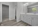 Bathroom features a dual-sink vanity with modern fixtures, and tiled floors at 10502 Oak Bend Blvd, Indianapolis, IN 46239