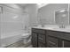 Bathroom features a bathtub, shower, dual-sink vanity, and modern fixtures at 10502 Oak Bend Blvd, Indianapolis, IN 46239