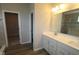Bathroom with double vanity, white cabinetry, and tiled shower with glass doors, plus a walk in closet at 10502 Oak Bend Blvd, Indianapolis, IN 46239