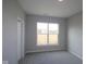 A cozy bedroom with neutral walls, plush gray carpeting, and a bright window at 10502 Oak Bend Blvd, Indianapolis, IN 46239
