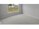 The bedroom has soft neutral carpeting and a large window overlooking the home's lawn at 10502 Oak Bend Blvd, Indianapolis, IN 46239