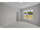 Bright bedroom features a large window offering plentiful natural light and neutral carpeting at 10502 Oak Bend Blvd, Indianapolis, IN 46239