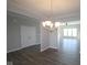 Elegant dining room with chandelier, and an open layout leading into other living spaces with plank flooring at 10502 Oak Bend Blvd, Indianapolis, IN 46239